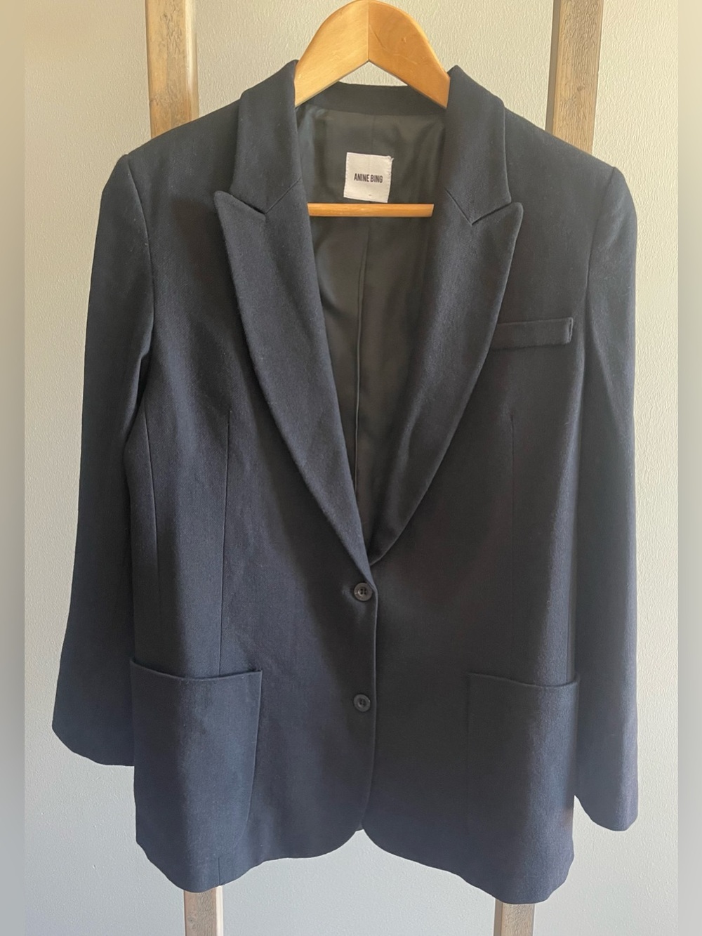 Anine Bing black wool blend blazer with notched lapel and a two-button closure